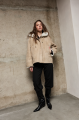 Stylish suede sheepskin coat made of natural sheepskin in beige color with a hood